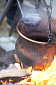 Cauldron with ladle above open fire in Zermatt, Valais, Switzerland