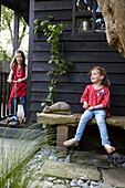Girls playing in garden of London townhouse, England, UK