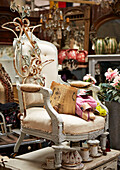 Vintage armchair with metalwork in Evershot antique shop, Dorset, kent, UK