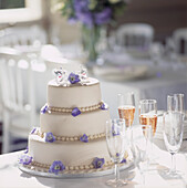 Wedding cake decorated with purple flowers