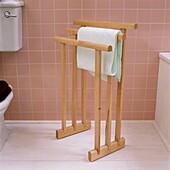 Towel rail in tiled pink bathroom