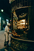 Chicken roasting on spits in a street stall in Barcelona