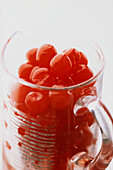 Glass mug full of cocktail cherries