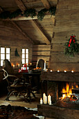 Christmas decorations in log cabin interior with fireplace