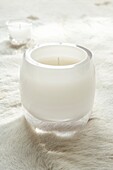 Clear glass candle holders on a fur throw