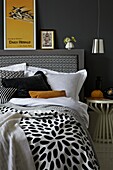 Black and white bedroom with yellow accent colours and vintage poster