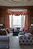 Decorated coffee table and sofas in drawing room of Tiverton country home,  Devon,  England,  UK