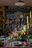 Dining table with centrepiece for Christmas dinner in Benenden cottage,  Kent,  England,  UK