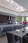 Light grey open plan kitchen and dining room in contemporary Haywards Heath home,  West Sussex,  England,  UK