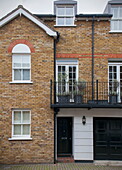 Brick facade with balcony of Battersea home,  London,  England,  UK