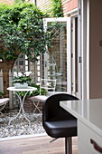 View through doorway to garden courtyard of Battersea home,  London,  England,  UK