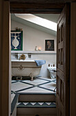 View through wooden doorway to split-level bathroom in Lotte et Garonne farmhouse  France