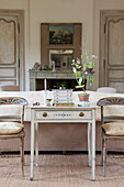 Houseplant on desk with pair of painted chairs in living room of Dordogne cottage  Perigueux  France