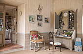 Upholstered armchair with artwork and writing desk in Dordogne cottage  Perigueux  France