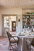 Bookcase and dining table with terracotta floor in Dordogne cottage  Perigueux  France