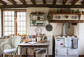 White AGA and leaded glass window in beamed High Halden kitchen  Kent  England  UK