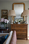 Pair of lamps on wooden chest of drawers in East Barsham cottage  Norfolk  England  UK