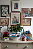 Framed artwork and desk lamp with gift-wrapped presents in London home  England  UK