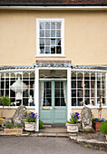 Lion statues at light blue front door of Suffolk home  England  UK