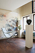 Retro chair and sculpture with large art canvas in Suffolk farmhouse  England  UK
