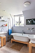 Lilac bathroom with freestanding bath and sinks in Norfolk coastguards cottage  England  UK