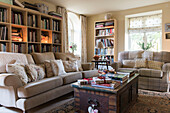 Bookcases and sofas in East Sussex coach house  England  UK