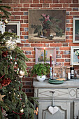 Artwork and sideboard with Christmas tree in East Sussex coach house  England  UK