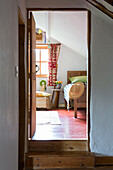 View through split-level doorway to bedroom of Devon cottage England UK