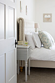 Pillows on double bed with headboard rivets in Petworth farmhouse West Sussex Kent