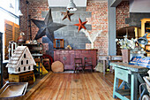 Large stars and vintage furniture in Edwardian antique shop West Sussex England UK