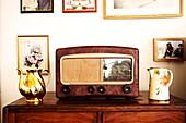 Vintage radio and jugs on wooden dresser in Birmingham home  England  UK