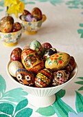 Hand-painted Easter eggs on kitchen table in London home   England   UK