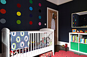 White cot in child's nursery of contemporary London family home   England   UK