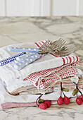 Spotted spoons and fork on folded tea towels in UK farmhouse kitchen