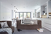 Brown sofas with black and white cushions in open plan London townhouse  England  UK