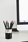 Sharp pencils in holder with computer screen London home  UK