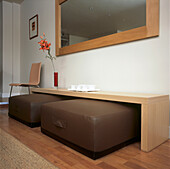 Hallway with large mirror and side table with storage for seating