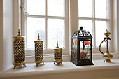 Assorted lanterns on windowsill of New Malden home, Surrey, England, UK