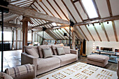 Seating area with beamed ceiling in watermill conversion 