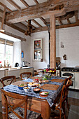 Placemats and lunch dishes on table in kitchen of watermill conversion