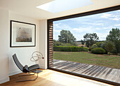 Black leather chair and sculpture ate large window in Essex home UK