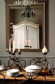 Painted French armoire reflected in dining room mirror