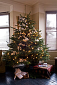 Christmas tree with fairylights and white floral decoration
