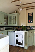 Country kitchen set below eaves in pastel green