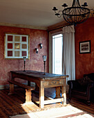 Rustic wooden table in red living room with white curtains