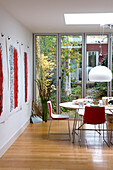 Dining area with pendant light and glass doors to garden