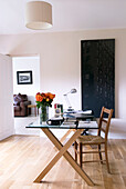 Glass desk and chair in the home office living room in background