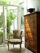 Corner of room with views through large window to conservatory