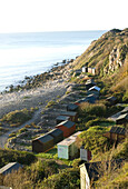 View of coast with beach huts Portland Dorset UK