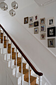 Picture frames over staircase with mirror balls